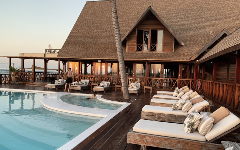 Luxury resort hotel pool surrounded by palm trees